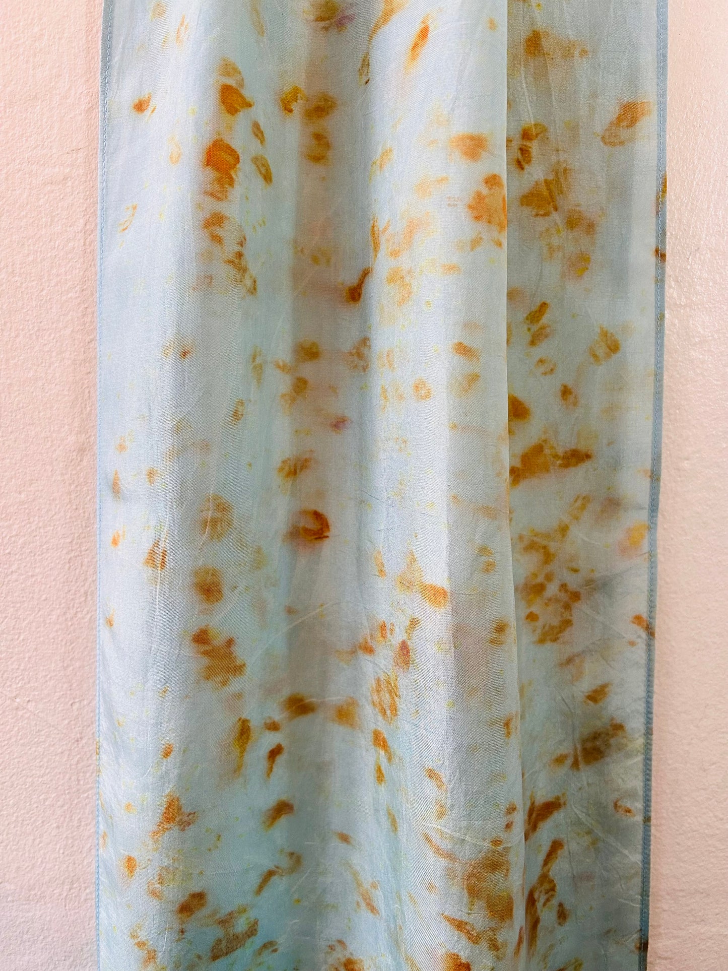 Pale indigo long silk scarf with orange cosmos naturally dyed print close up of pattern