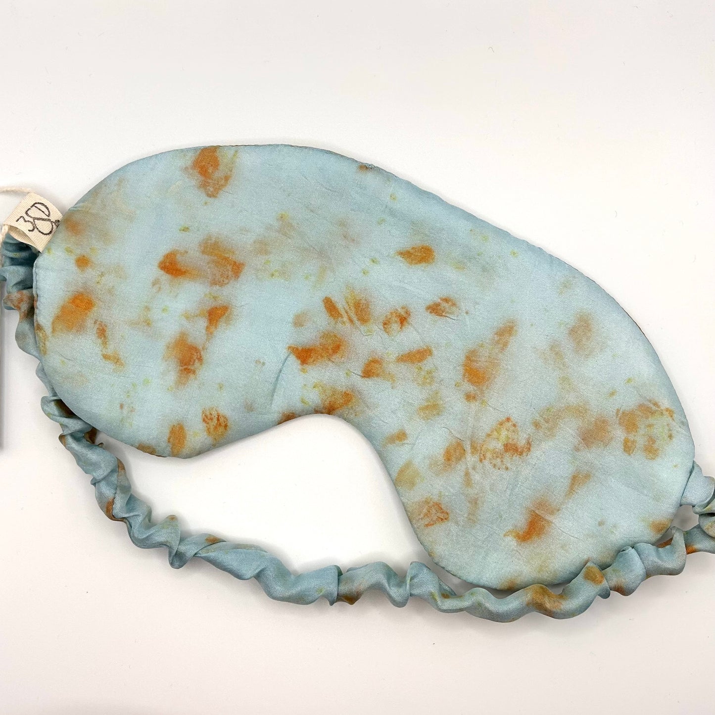 Pale indigo with orange cosmos naturally dyed silk printed eye mask with elastic to secure over eyes