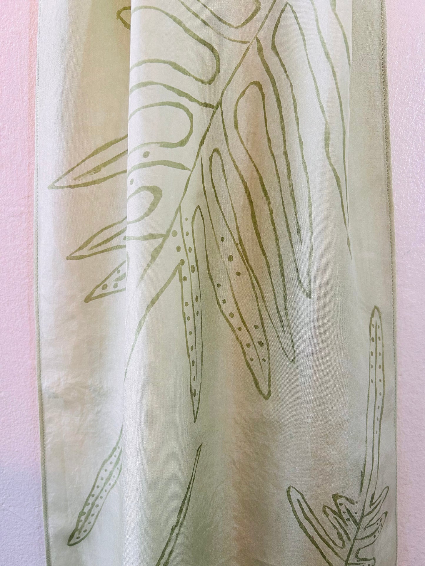 Pale green long silk scarf with naturally dyed hand-painted leaf print showing close up of pattern