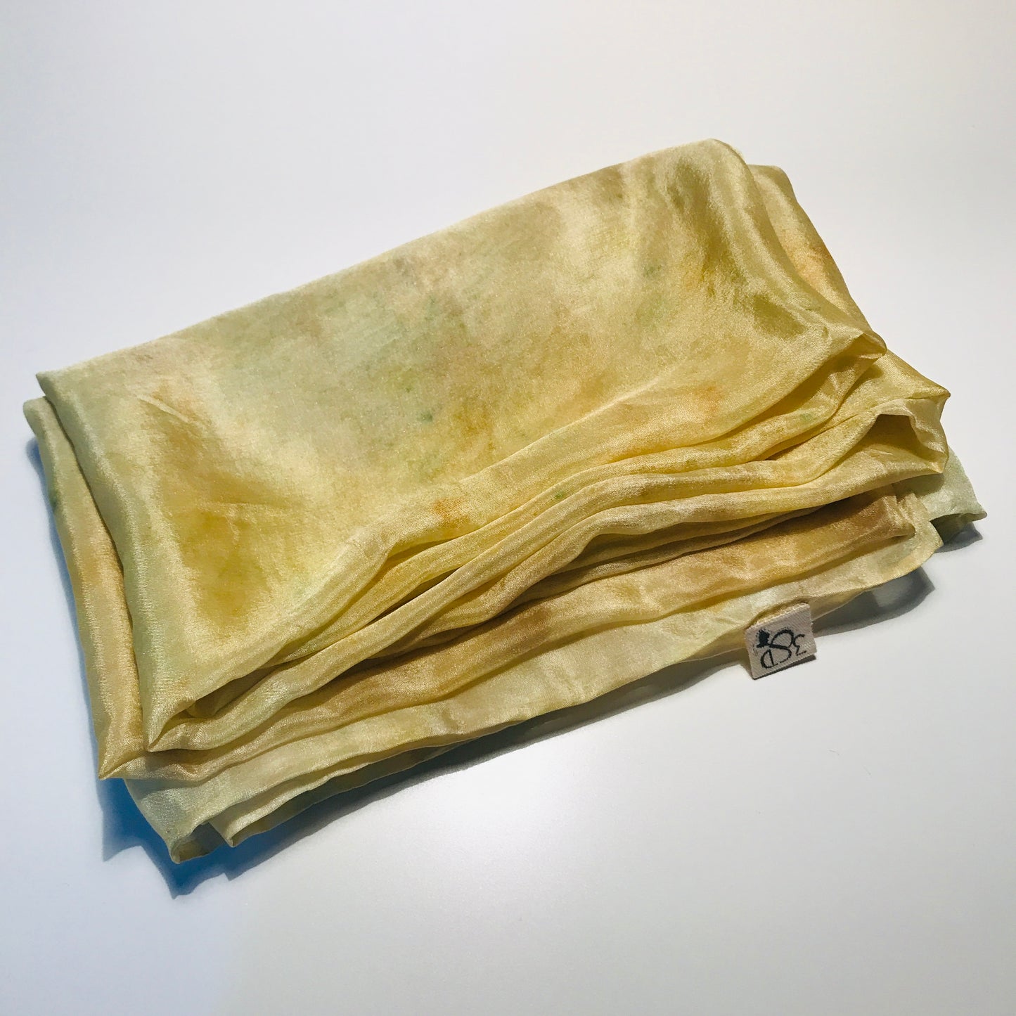 Yellow long silk scarf with naturally dyed marigold print folded