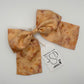 Naturally dyed beige camel and onion bundle dye printed silk hair-bow clip 