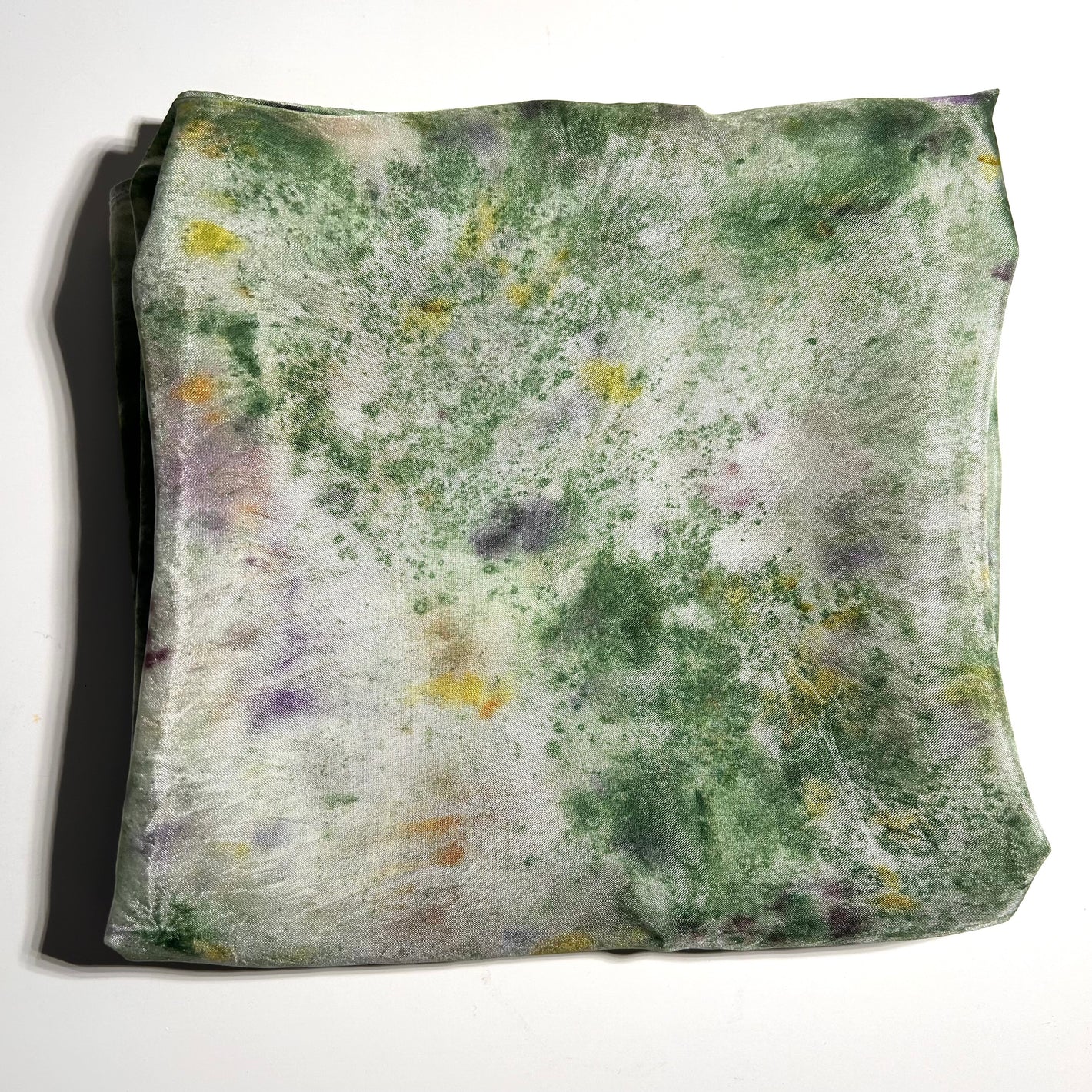 Green Garden print naturally dyed  silk square scarf  folded into a square