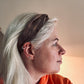Headshot model wearing the brown silk turban headband and orange hoody