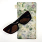 Green Garden Glasses Case naturally dyed silk, printed with Pansy petals and extract dye, displayed with Sunglasses