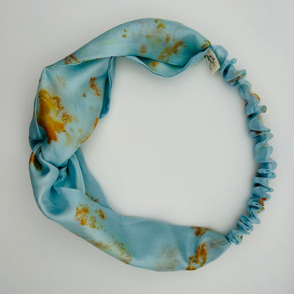 Pale indigo silk turban headband with elastic to secure over head which has been naturally dyed with orange cosmos flowers 