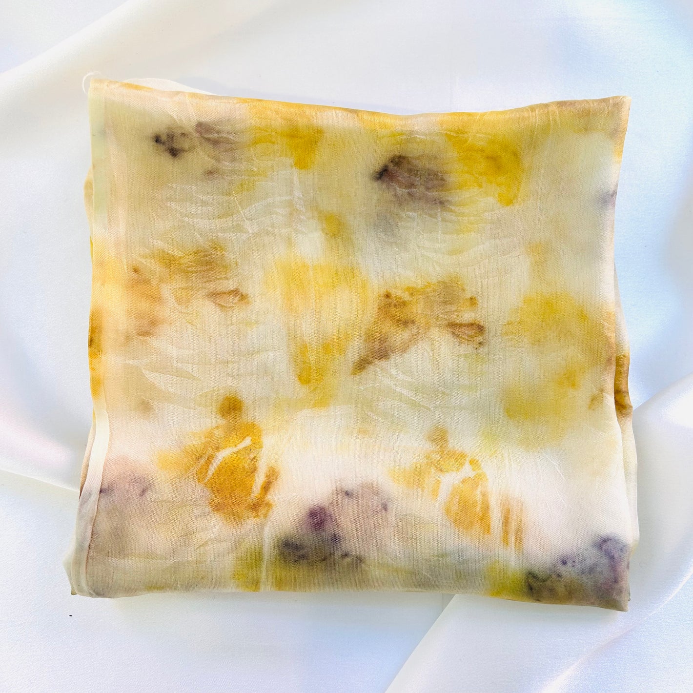 Pale lemon marigold naturally dyed  silk square scarf  folded into a square