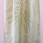 Pale green long silk scarf with naturally dyed hand-painted leaf print  showing close up of pattern 