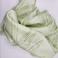 Pale green long silk scarf with naturally dyed hand-painted leaf print scrunched up
