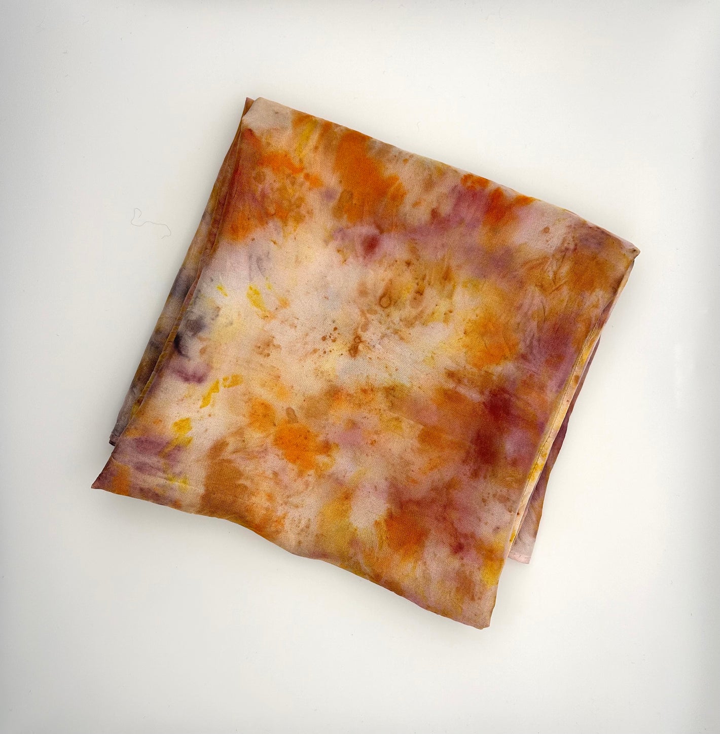 Plum, lemon and orange Dahlia naturally dyed silk square scarf folded into a square