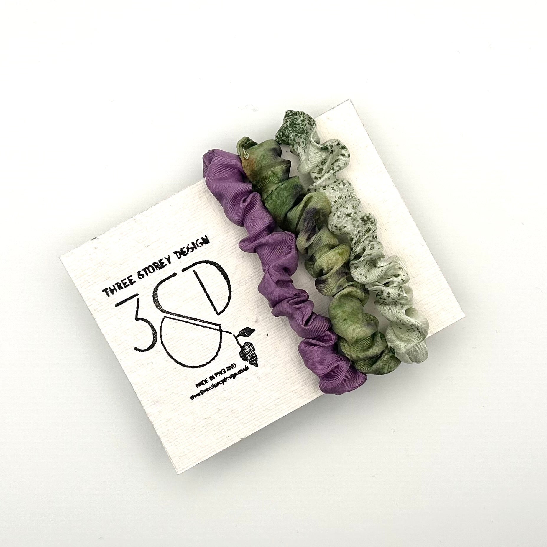 Purple , Green and Pale Green naturally dyed 3 pack mini silk scrunchies presented on plantable branded packaging