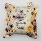 White Silk square lavender bag/sachet with Naturally dyed scabious black knight, orange cosmos, yellow marigold  print and cotton branded tab, wrapped in tracing paper product information sleeve