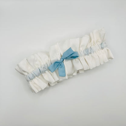 Front view of White Silk wedding garter with adjustable Indigo blue tied bow, ready to wear 